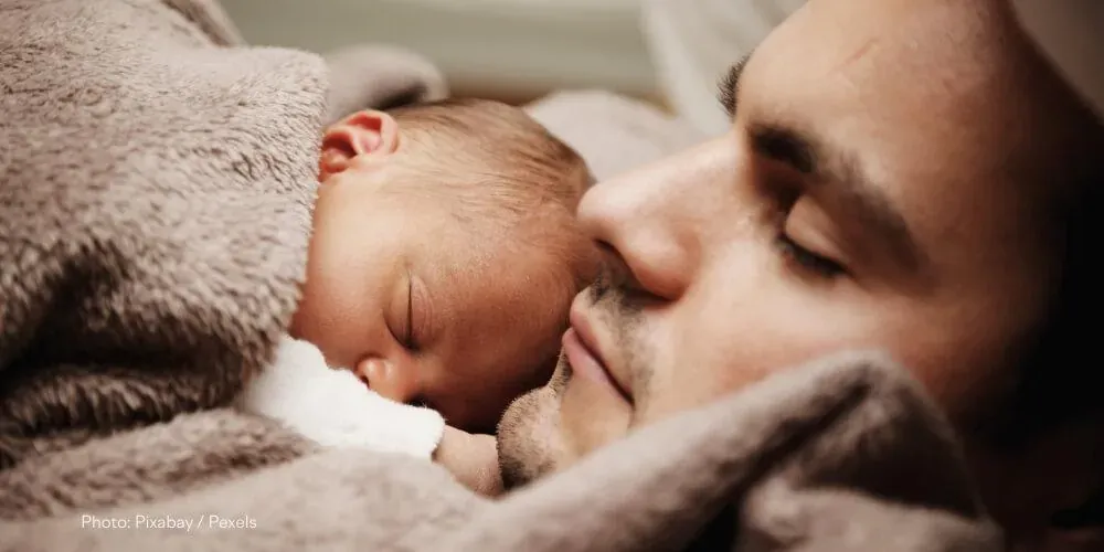 Why do newborns need to be held?